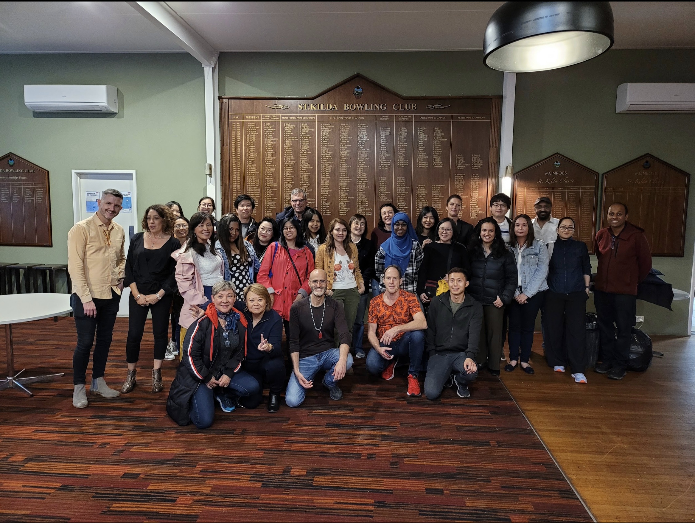 Community group gathered indoors before MANZU